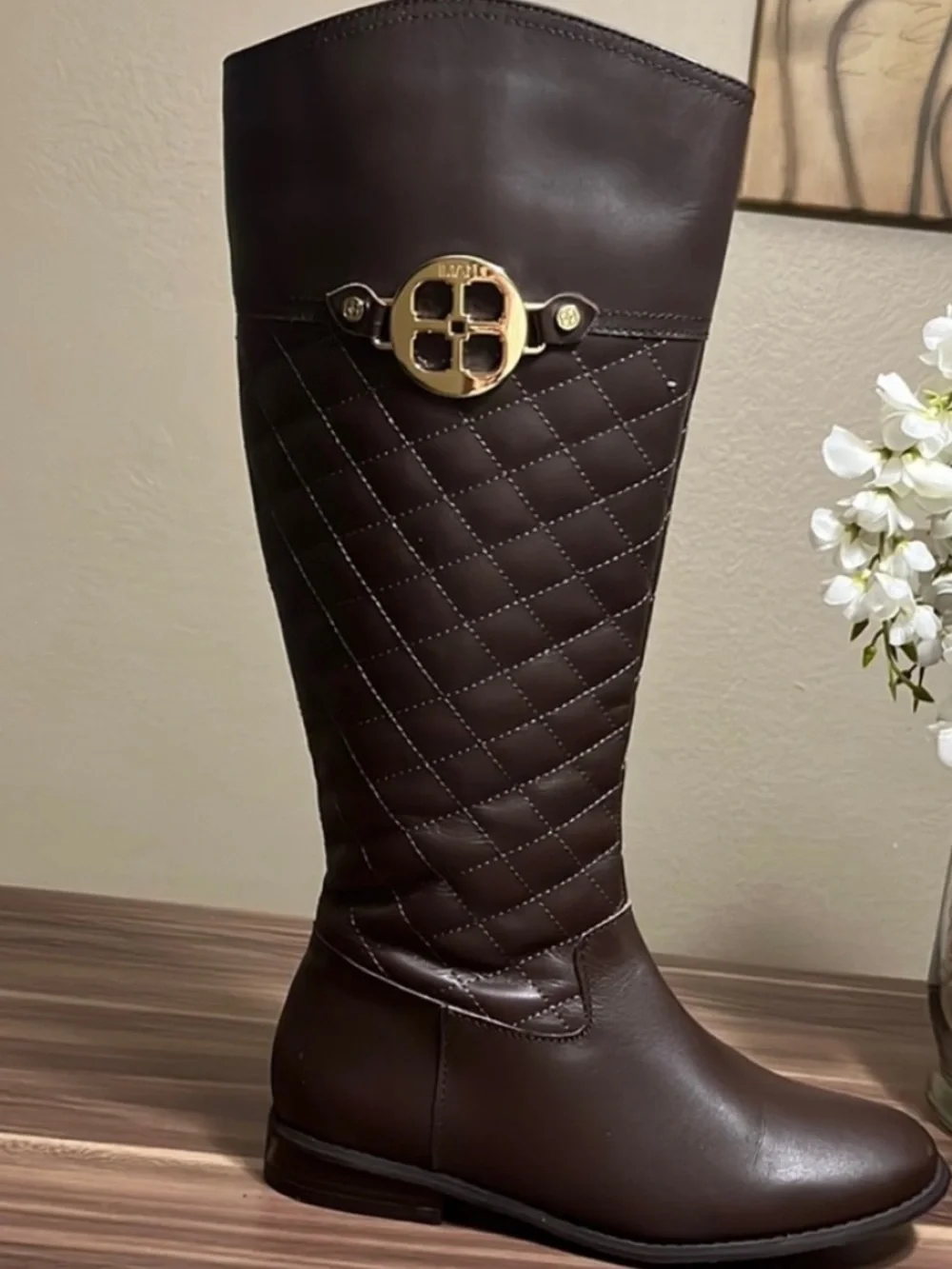 Iman Brown Quilted Knee-High Riding Boots with gold logo medallion